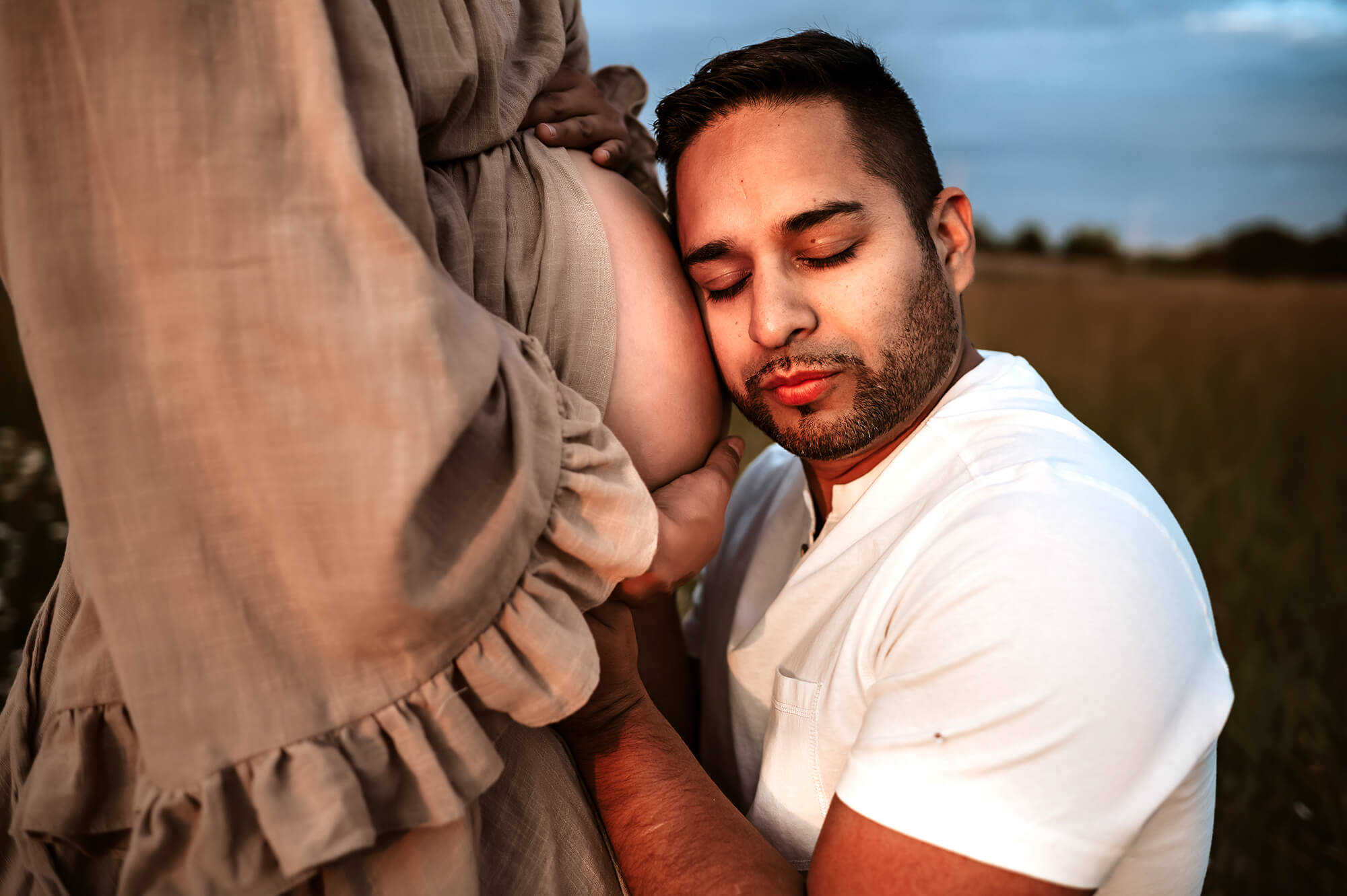 maternity photographer in kansas City captures pregnant couple cuddling after prenatal massage in kansas City