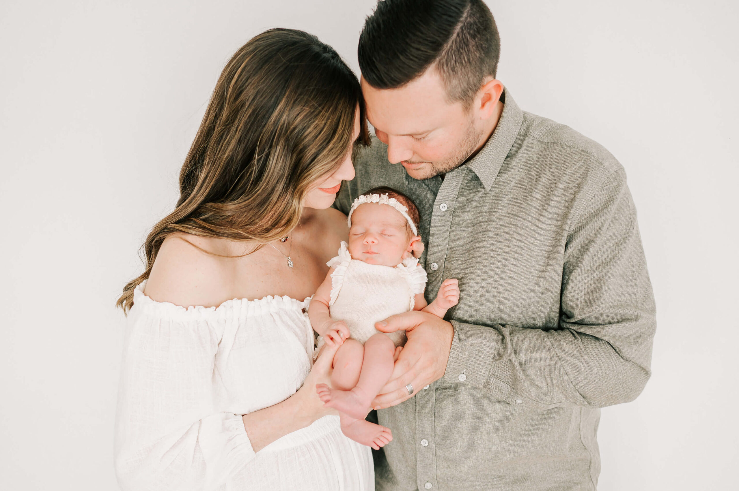parents holding baby girl captured by Springfield MO newborn photographer Jessica Kennedy of The XO Photography