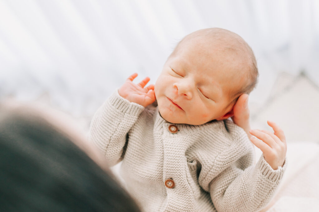 baby boy in mom hands captured by Springfield MO newborn photographer