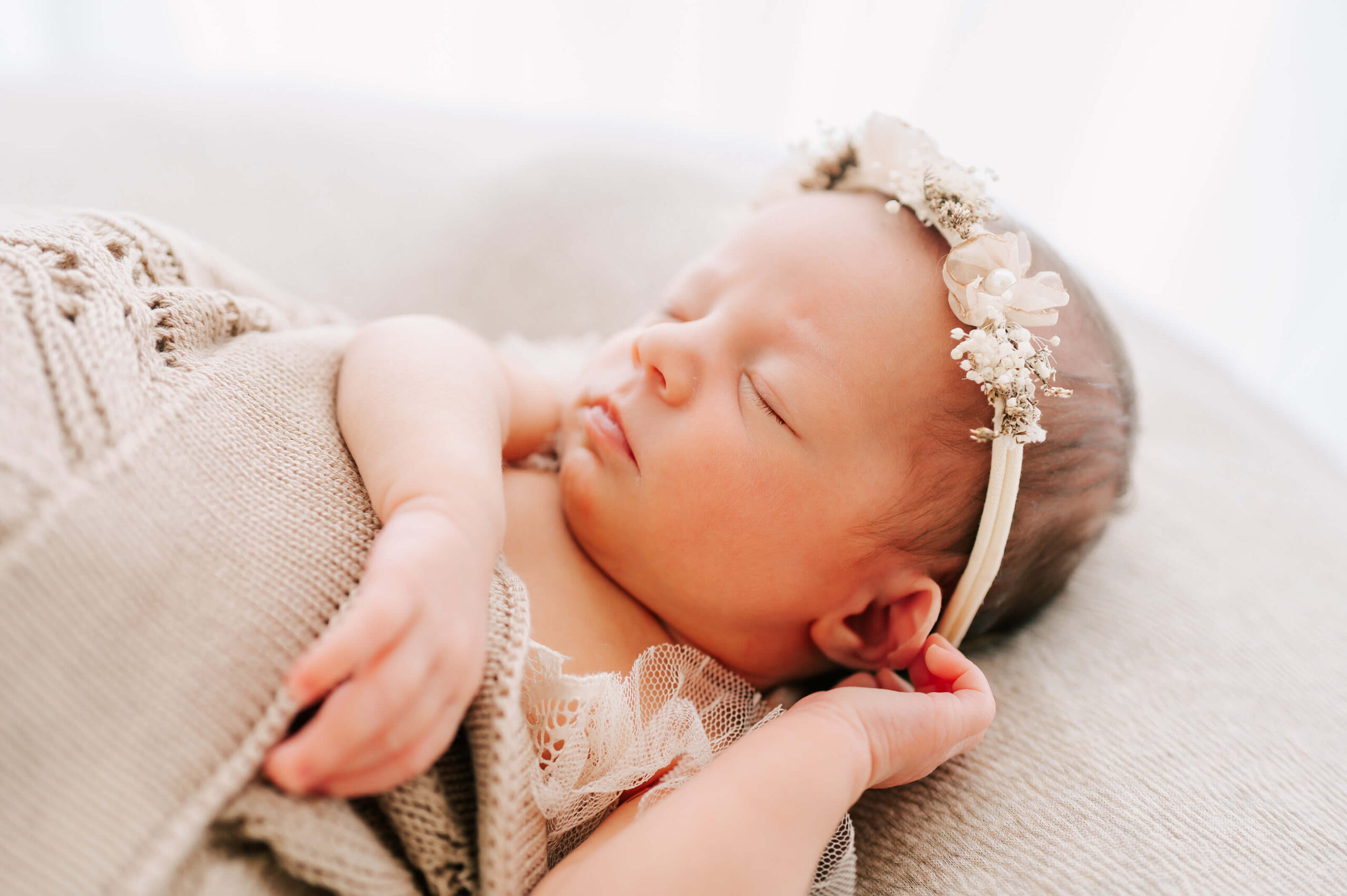 baby girl sleeping in bed during Springfield MO newborn photography session