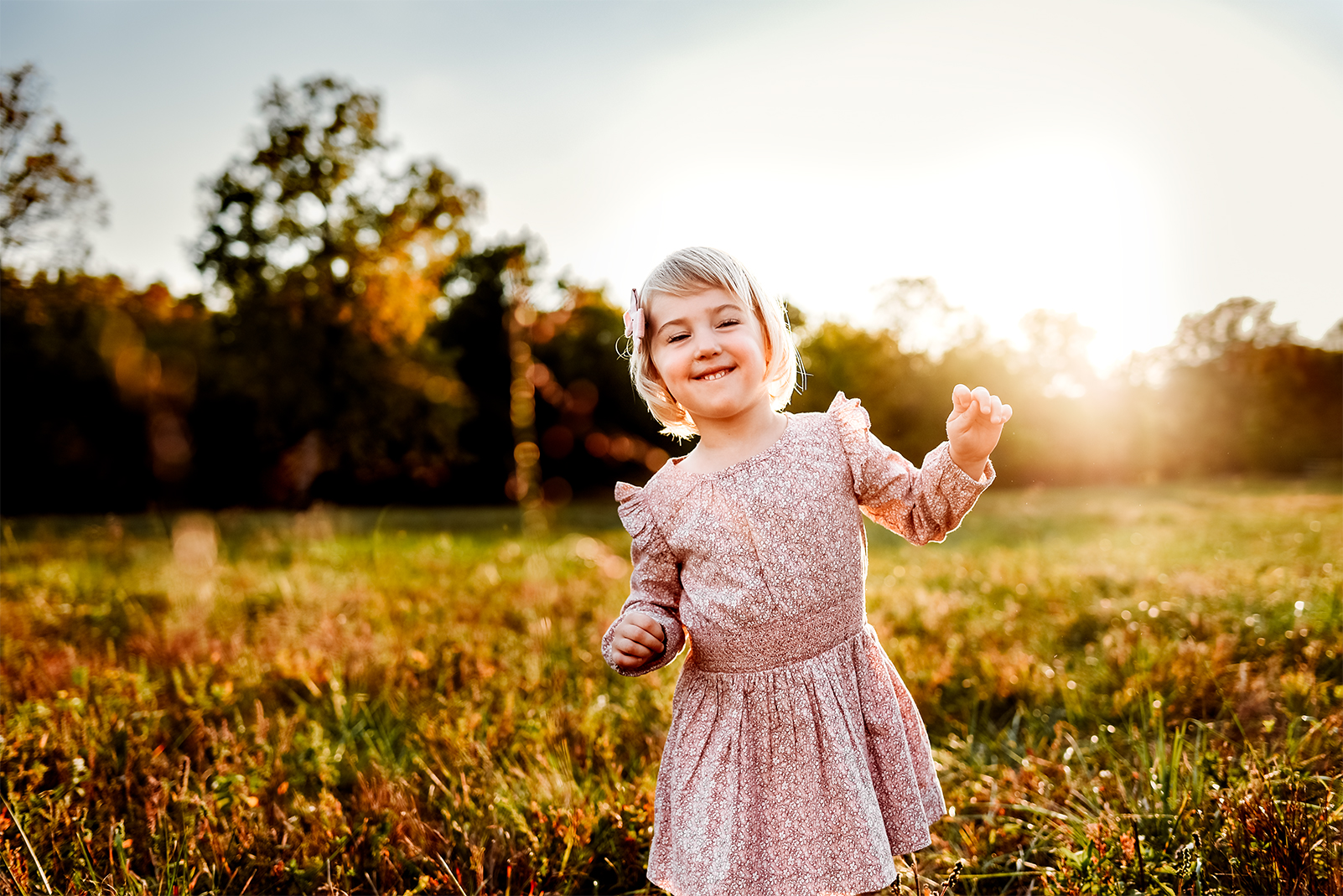Springfield MO family photographer captures little girl dancing in a field in the fall