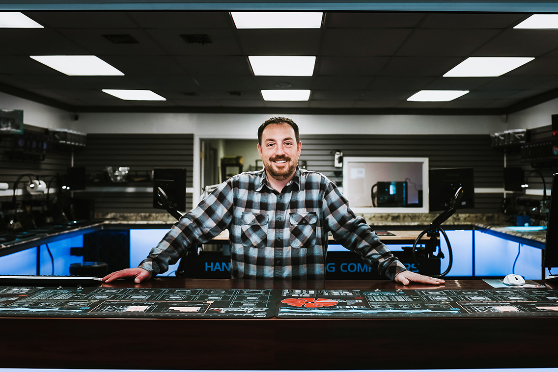 Springfield MO headshot photographer captures man standing at welcome desk of computer company