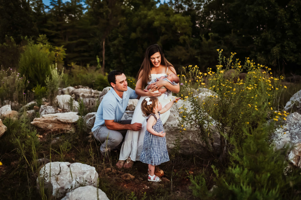 Kansas City Newborn photographer captures family picking flowers with toddler and newborn baby