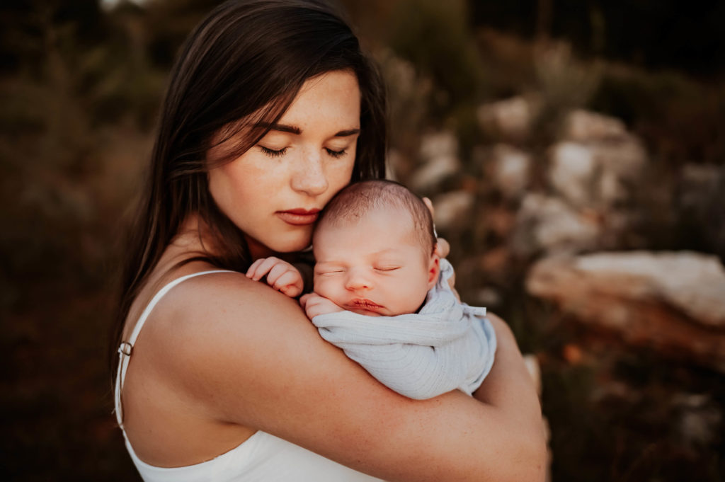 Kansas City newborn photographer captures mom cuddling newborn after visiting lactation consultant kansas city