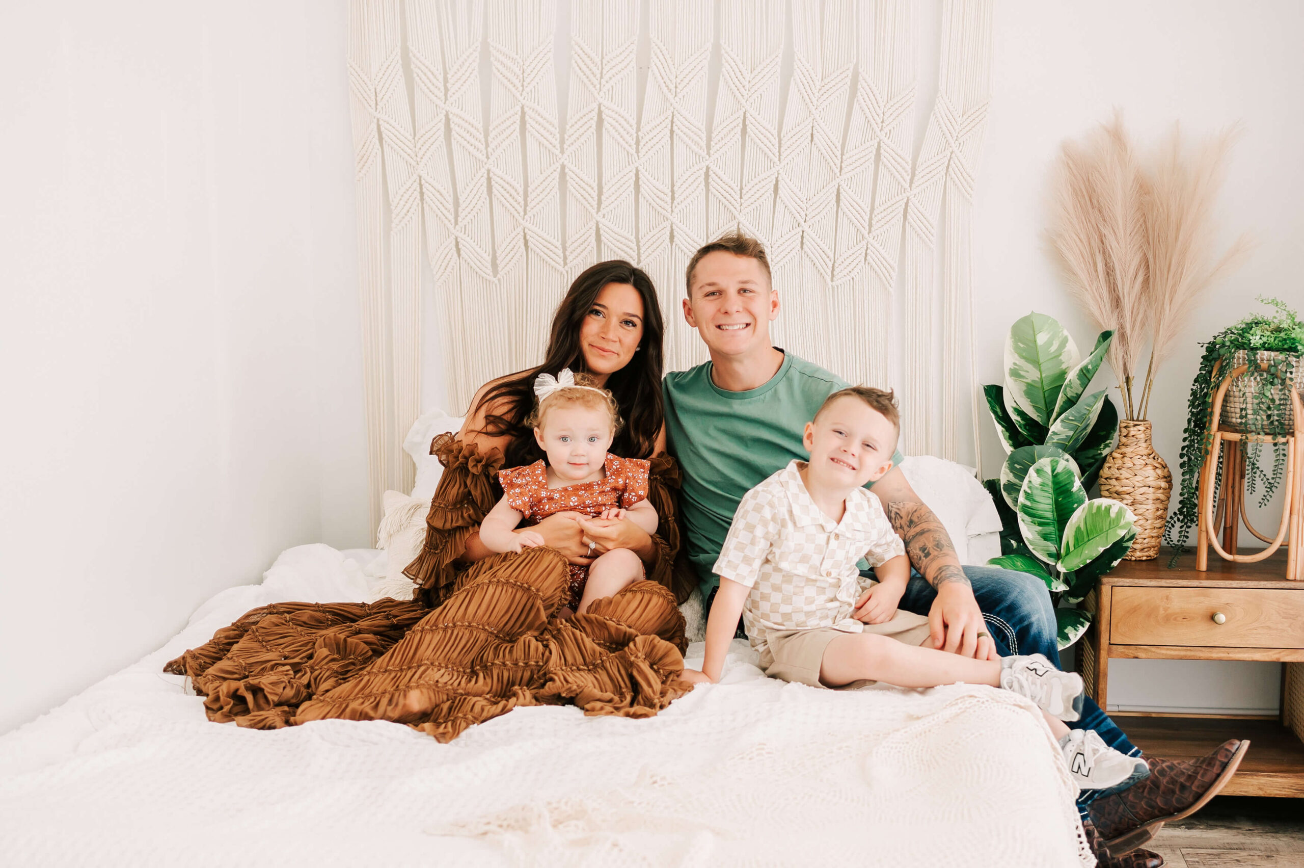 Springfield MO family photographer captures family cuddling on bed in photography studio