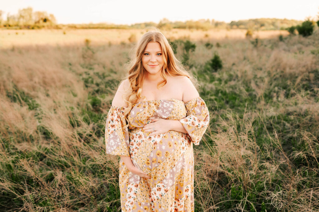 Kansas city maternity photographer captures mom in floral dress from maternity store in kansas city