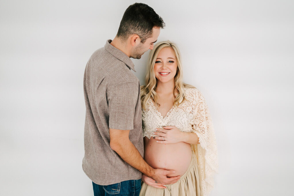 pregnant couple cuddling in maternity photography studio in Springfield MO