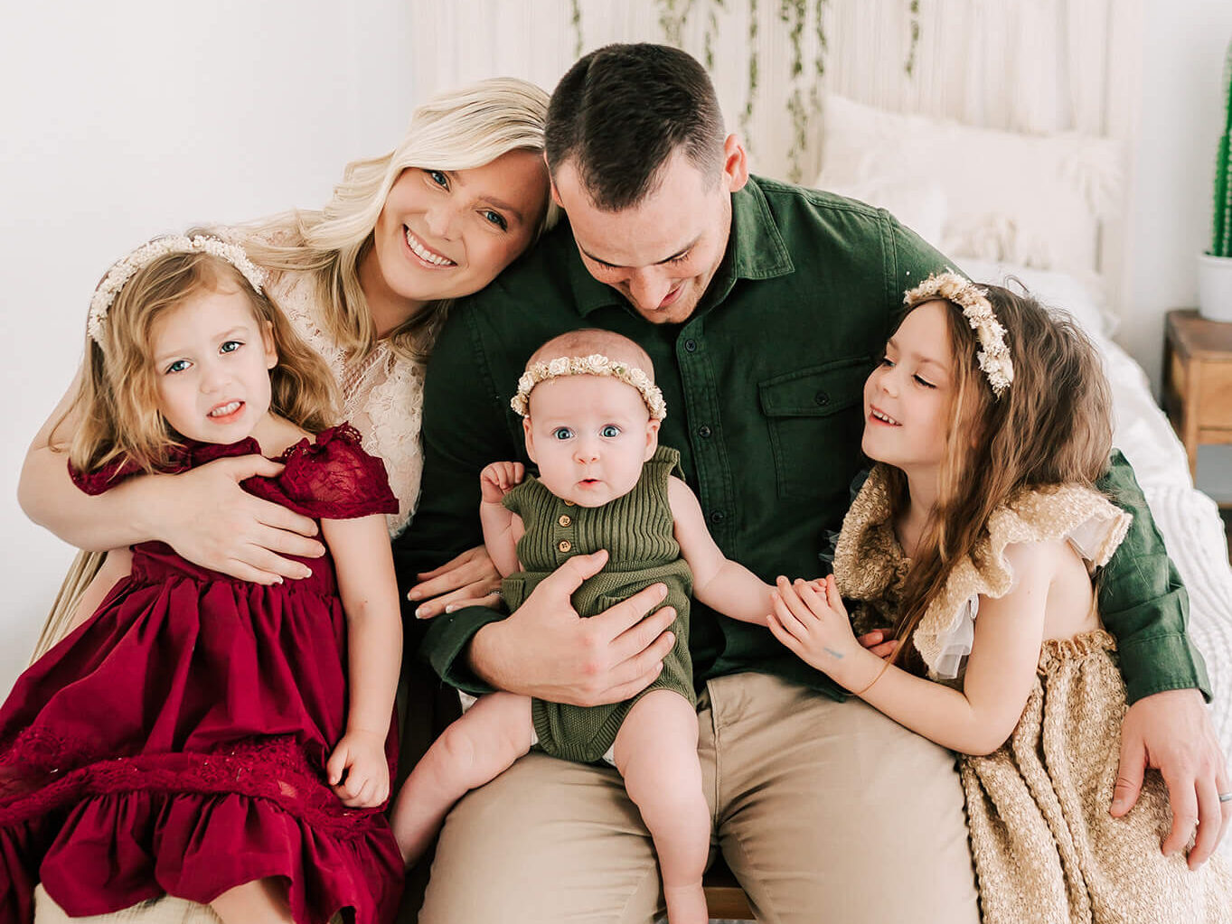 family cuddling on bench in studio captured by Springfield MO family photographer Jessica Kennedy of The XO Photography