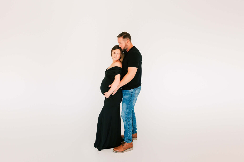 couple standing in maternity photography studio in kansas city