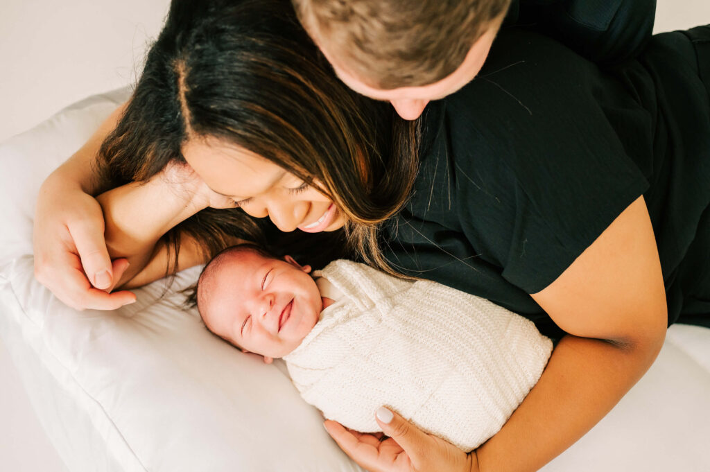 parenting holding smiling newborn same face as found in 4d ultrasound in Branson, MO